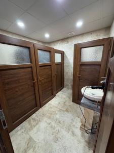 a bathroom with two wooden doors and a sink at Wanderlust Inn Cappadocia in Uçhisar +15 photos
