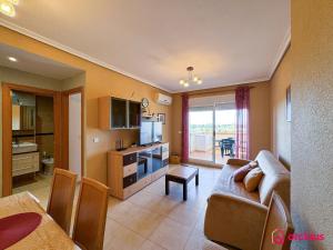 a living room with a couch and a kitchen at Paraíso Natural in Cabanes