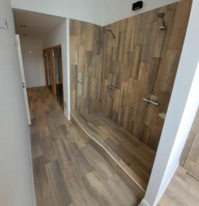 a bathroom with a shower with wooden walls at Luxury Studio in San Telmo - The Best location in Buenos Aires +23 photos