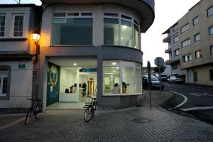 a building with two bikes parked outside of it at Albergue Oceanus Finisterre in Finisterre