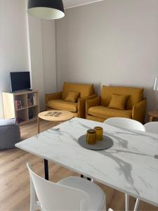 a living room with a white table and chairs at Verde Acqua Suite in Lecco