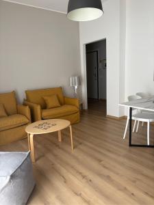 a living room with a couch and a table at Verde Acqua Suite in Lecco