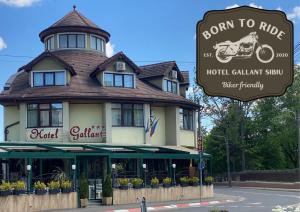 a sign in front of a hotel with a building at Hotel Gallant Sibiu in Sibiu