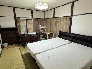 Postel nebo postele na pokoji v ubytování 東京近隣 蔵元荘 駅近 交通便利