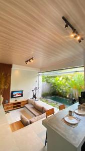 a living room with a couch and an aquarium at 2 Bedroom Villa In Sanur Harbour in Sanur