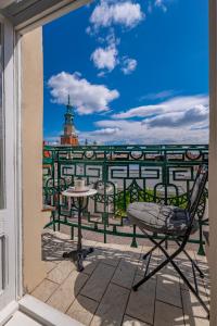 a patio with a table and chairs on a balcony at View-Apartments Stary Rynek 75 in Poznań