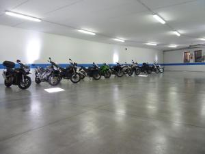 a row of motorcycles parked in a garage at Active Hotel Pineta in Baselga di Pinè