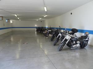 a row of motorcycles parked in a garage at Active Hotel Pineta in Baselga di Pinè +51 photos