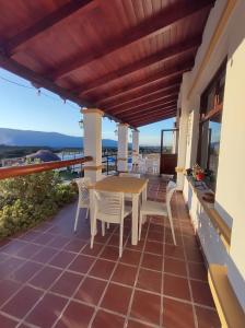 a patio with a table and chairs on a balcony at Altos de Amaicha Posada Boutique in Amaicha del Valle
