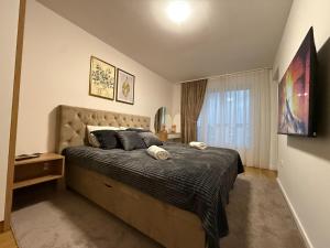 a bedroom with a large bed and a window at River Walk Sarajevo-Ilidza Best Apartman in Sarajevo +20 photos