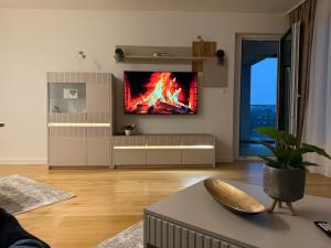 a living room with a fire on the wall at River Walk Sarajevo-Ilidza Best Apartman in Sarajevo
