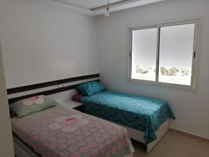 Postel nebo postele na pokoji v ubytování Appartement familial avec piscine Imi Ouaddar + 40 fotografií