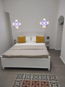 a bedroom with a large bed with yellow pillows at Modern Retrò Alloggio Vacanze in Molfetta