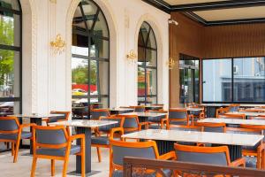 a restaurant with tables and chairs and windows at Turistik Palas Otel in Diyarbakır
