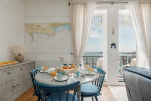 a dining room with a table with fruit on it at Balcony Apartment in Swanage +23 photos