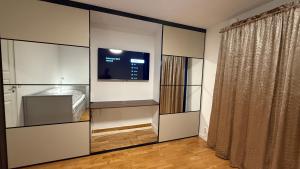 a room with a large white closet with a tv at Villa South Beach in Karlskrona