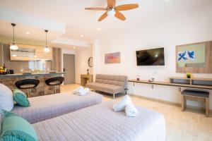 a living room with two beds and a kitchen at Diamond Apartments 3 in Kardamaina