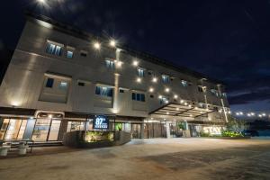 a large building with lights on it at night at Stay Kertapati Hotel in Kertapati