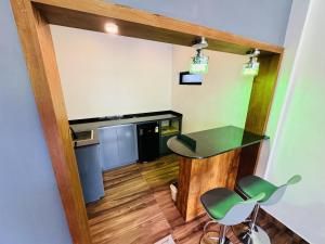 a room with a table and two chairs and a kitchen at AYD-IN BY GREENLEAVES Resort in Vythiri