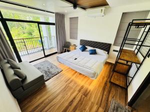 a bedroom with a bed and a ladder at AYD-IN BY GREENLEAVES Resort in Vythiri +11 photos