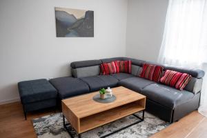 a living room with a couch and a coffee table at Stan na dan Gornji Vakuf Uskoplje in Gornji Vakuf