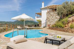 a villa with a swimming pool and a house at Kohili Villas - Sea View Residences in Skopelos Town