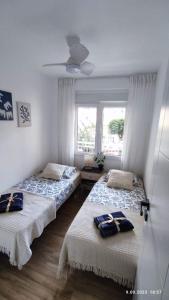 two beds in a room with a window at Sunny La Mata Apartment, Spain in La Mata +41 photos