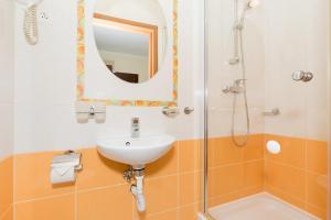 a bathroom with a sink and a mirror and a shower at OW Diament in Pobierowo +32 photos