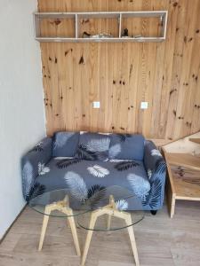 a blue couch in a room with a table at A la campagne in Saint-Denis