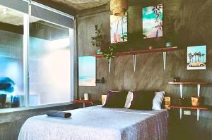 a bedroom with a bed and a large window at SUMMER STAY A Starlink in General Luna