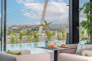 a view of a pool from a hotel room with a table and chairs at Kenzi Sidi Maarouf in Casablanca