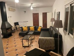 a living room with a couch and a fireplace at Lovely 10-Bed Villa with Private Pool & Garden in Cacin +37 photos