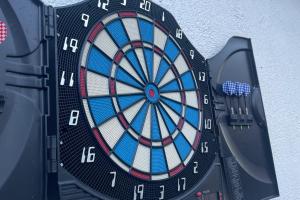 a close up of a dartboard with two darts at Lovely 10-Bed Villa with Private Pool & Garden in Cacin