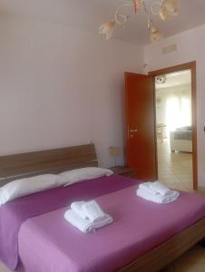Ένα ή περισσότερα κρεβάτια σε δωμάτιο στο Don Michele Apartments
