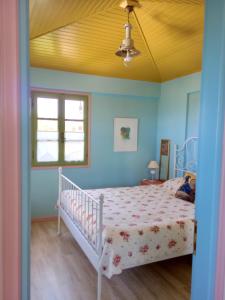 a bedroom with a bed and a ceiling at Monemvasia's Art House in Ayía Kiriakí