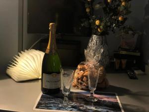 a bottle of wine and two glasses on a table at Piazza Di Spagna Prestige in Rome