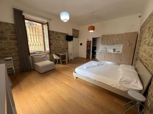 a large bedroom with a bed and a kitchen at Agropoli loft 23 in Agropoli