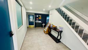 a hallway with a staircase and a stair case at Motel 6 McGraw, NY - Cortland in McGraw