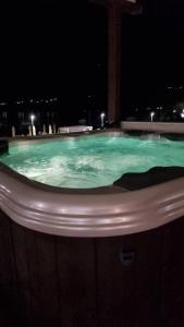 una gran piscina de agua verde por la noche en Olive Coast Apartments Baošići Center, en Herceg-Novi