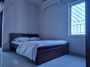 Ένα ή περισσότερα κρεβάτια σε δωμάτιο στο Econ Stay in New Apartment, Jigatola, Dhanmondi, Dhaka, BD