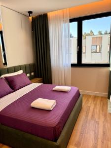 a bedroom with a bed with two towels on it at Pearl Pool Luxury Villa in Golem +126 photos
