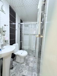a bathroom with a toilet and a sink and a shower at Grand Hurriyet Hotel in Istanbul +27 photos
