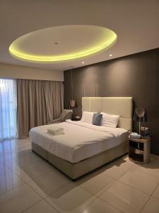 a bedroom with a large bed with a yellow ceiling at 4905 Luxury View By Royal Sky Vacation Homes Paramount Tower A in Dubai