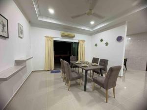 a dining room with a table and chairs at 25 pax Golf Resort Private Villa in Kulim