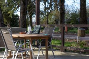 a wooden table and chairs on a patio at Agriturismo Valpagliaro in Formignana