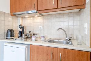 a kitchen with a sink and a counter top at Panorama studios 3 in Póndi