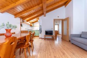 a living room with a wooden table and a couch at La Casa di Elvira-Mansarda in Alleghe