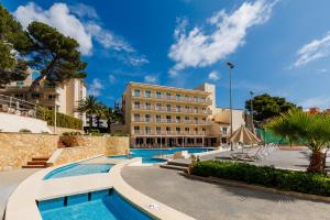 a hotel with two pools and a building at O7 Club Cala Ratjada in Cala Ratjada