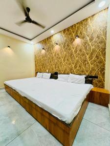 a bed in a room with a wall at Hotel Naagshree in Ujjain +20 photos
