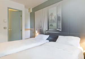Postel nebo postele na pokoji v ubytování B&B HOTEL Moulins